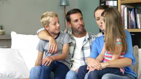 Cute-family-talking-sitting-on-the-couch