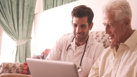 Senior-man-using-laptop-with-doctor