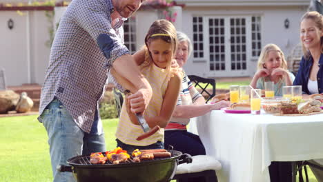 Family-having-a-barbecue-together-in-garden
