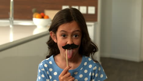 Daughter-with-fake-mustaches-making-faces