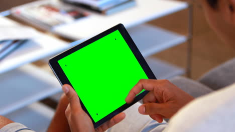 Man-using-a-tablet-sitting-on-the-couch