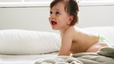 Cute-baby-playing-on-a-bed-