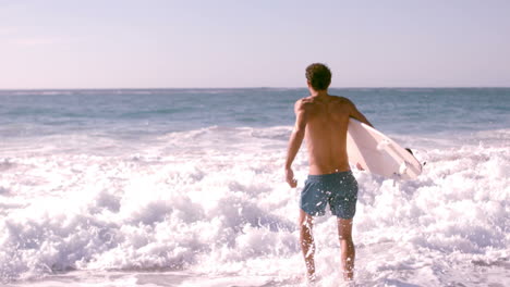 A-man-is-running-with-his-surfboard-