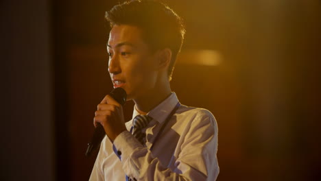 Young-Asian-businessman-speaking-in-business-seminar-at-auditorium-4k