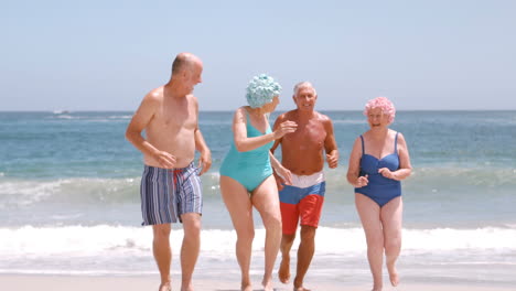 Mature-group-of-people-are-running-on-the-beach