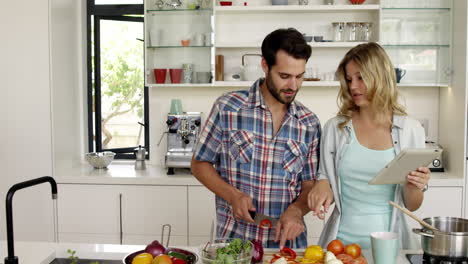 Girlfriend-showing-her-digital-tablet-to-her-boyfriend