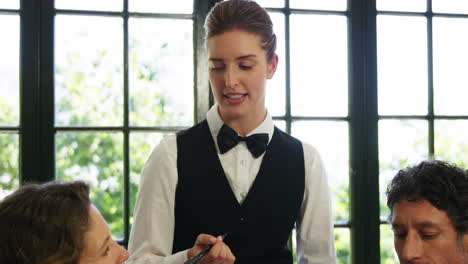 Waitress-taking-an-order-in-restaurant