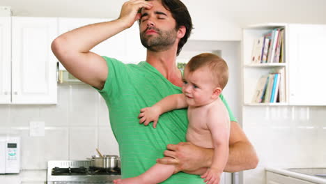 Frustrated-father-carrying-his-baby