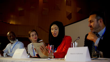 A-diverse-group-of-professionals-discussing-at-conference-table