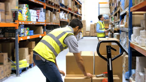 Worker-sealing-cardboard-box-with-packing-tape