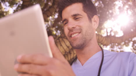 Male-doctor-using-digital-tablet-in-the-backyard