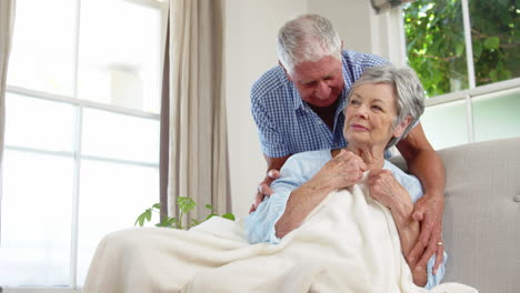 Senior-couple-talking-and-embracing