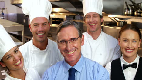 Group-of-employees-posing-with-their-boss