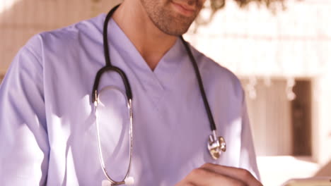 Male-doctor-using-digital-tablet-in-the-backyard