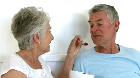 Senior-woman-feeding-her-husband
