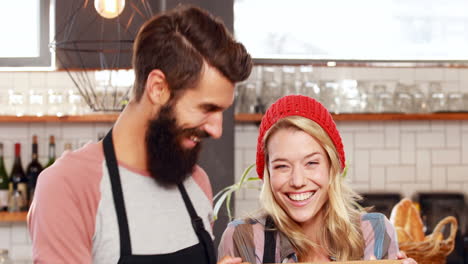 Hipster-couple-holding-open-sign