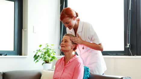 Nurse-doing-facial-massage-to-her-senior-patient
