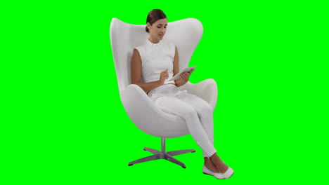 A-woman-sitting-and-using-digital-tablet