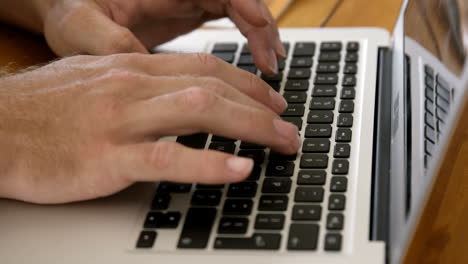 Close-up-view-of-masculine-hands-typing-on-a-laptop