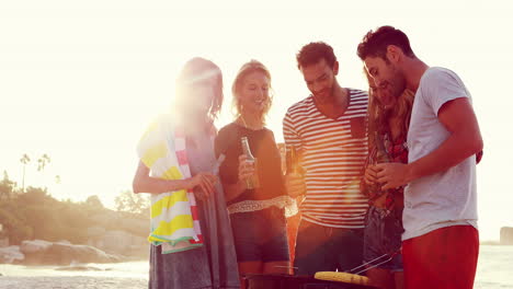 Happy-friends-holding-beers-and-cooking-meat