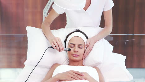 Relaxed-brunette-having-facial-treatment