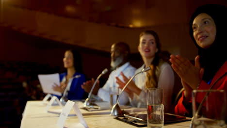 Happy-multi-ethnic-business-people-applauding-in-business-seminar-in-auditorium-4k