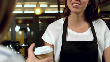 Barista-giving-coffee-to-a-customer