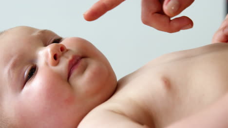 Close-up-someone-touching-carefully-a-baby
