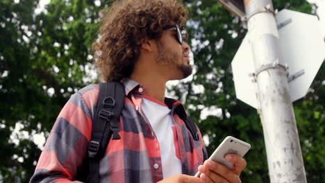 Man-holding-mobile-phone-outdoors