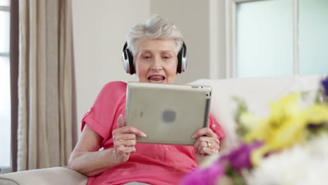 Senior-woman-listening-music-with-headphone