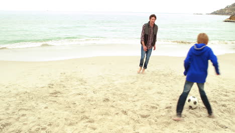 Father-and-son-playing-football