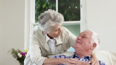 Senior-couple-embracing-on-couch