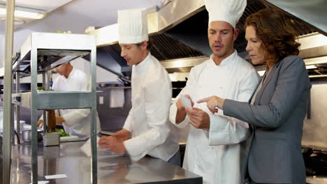 Employer-looking-at-chefs-taking-orders