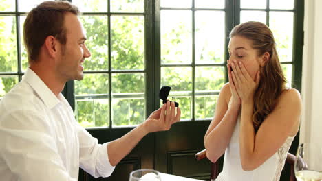 Couple-hugging-in-a-restaurant-after-proposal