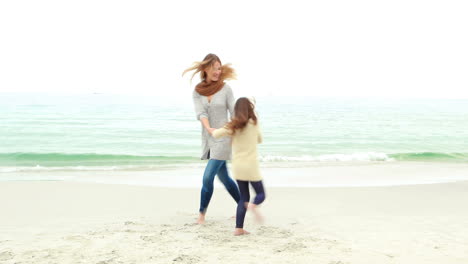 Mother-and-daughter-playing-on-the-beach