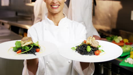 Chef-showing-plates-of-spaghetti