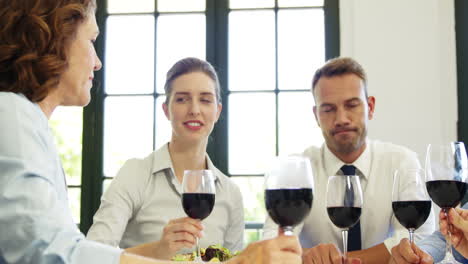 Business-people-toasting-with-red-wine