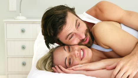 Cute-couple-lying-on-a-bed-embracing-each-other