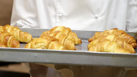 Chef-showing-tray-of-croissants