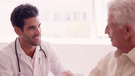 Male-doctor-consoling-to-a-senior-patient