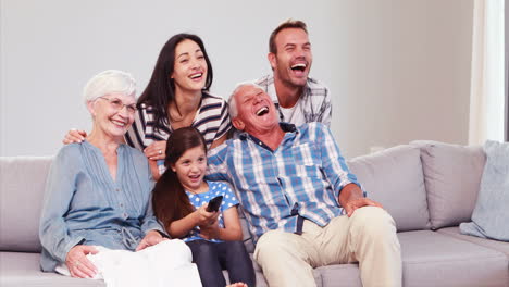 Extended-family-laughing-while-watching-tv