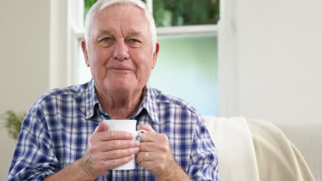 Old-man-enjoying-coffee-at-home