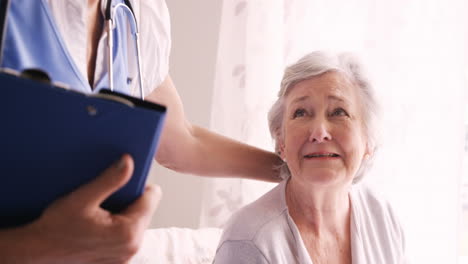 Female-doctor-consoling-to-a-senior-woman