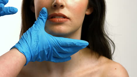 Plastic-surgeon-touching-woman-face