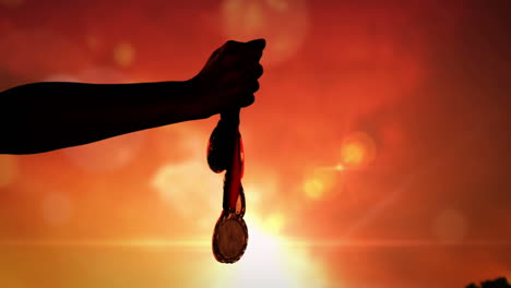 Silhouette-of-a-hand-throwing-medals