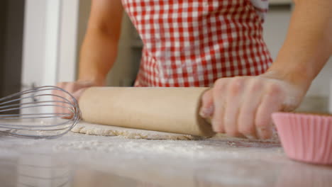 Woman-using-rolling-pin-for-baking