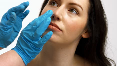 Plastic-surgeon-touching-woman-face