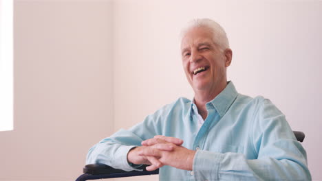 Happy-senior-man-sitting-on-the-wheelchair