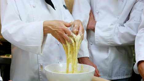 Chef-making-dough-in-commercial-kitchen