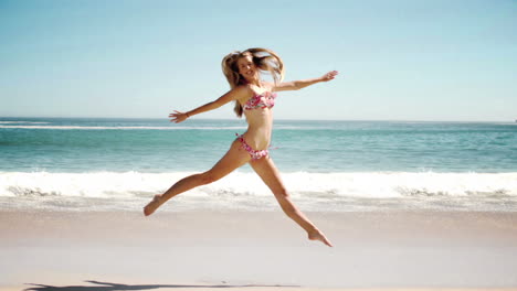 Happy-young-woman-jumping-on-beach-in-cinemagraph
